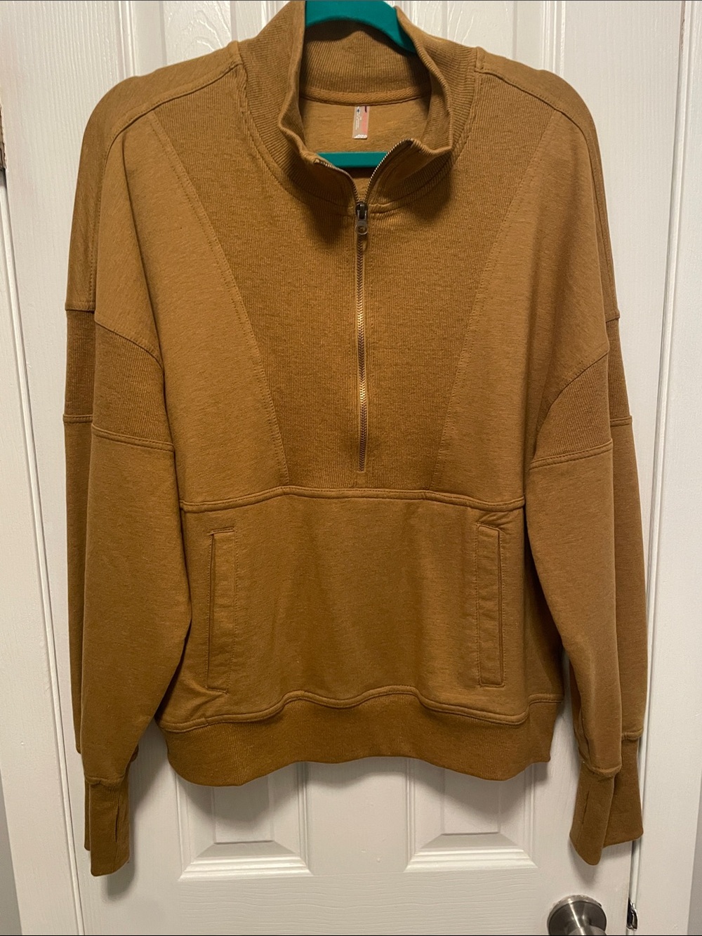 Women’s size large Free People top in a mustard color brown